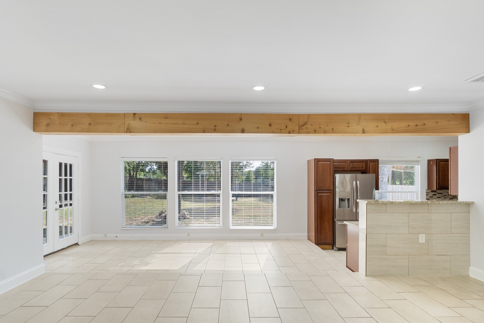 Bright open living space with backyard view